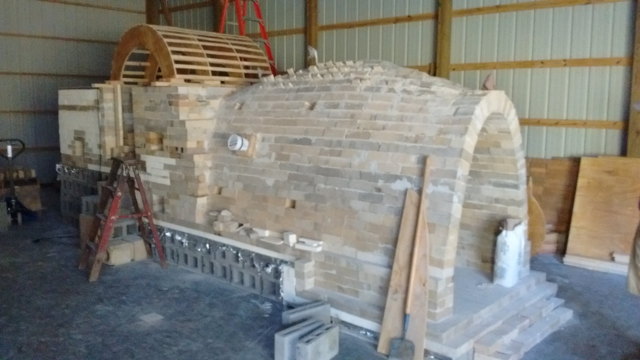 The arch form is supported by concrete blocks inside the second chamber. It is square, straight, and level.