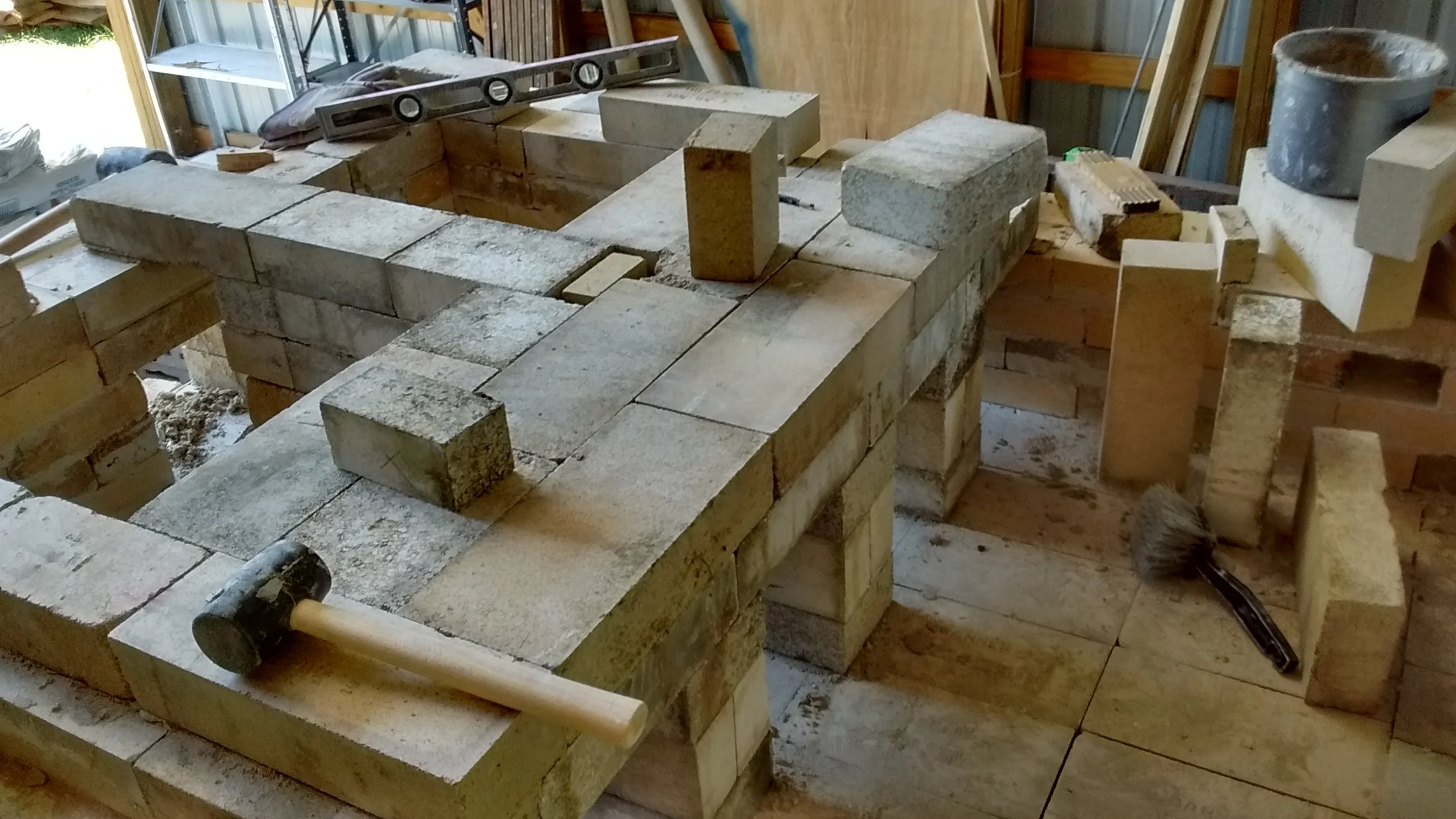 Now we understand the exit flues and chimney base. Very few of the bricks in this kiln are standard sizes or shapes, so there was a lot of head-scratching to make them fit a kiln designed around a 9" straight.