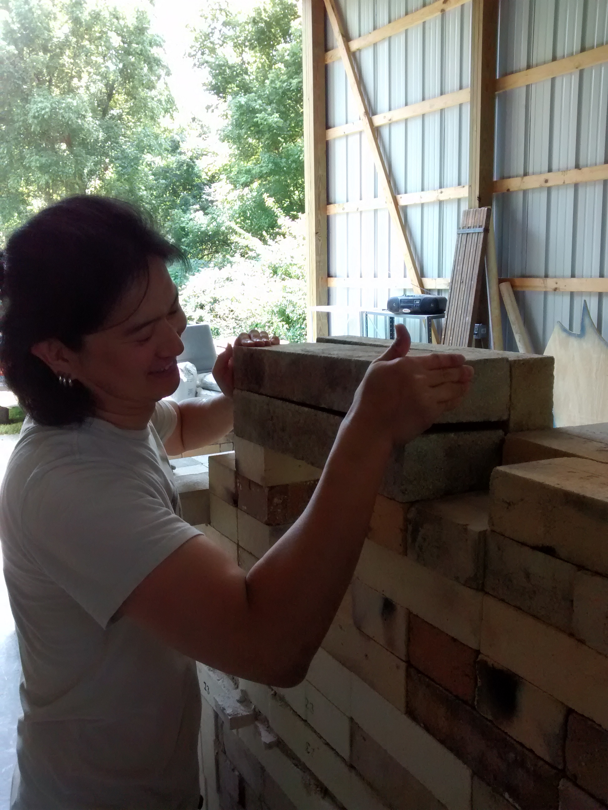Yoshi placing the 18x4.5x3" lintel bricks over the stoke hole of the second chamber. These bricks were from then-on known as Yoshi Bricks.