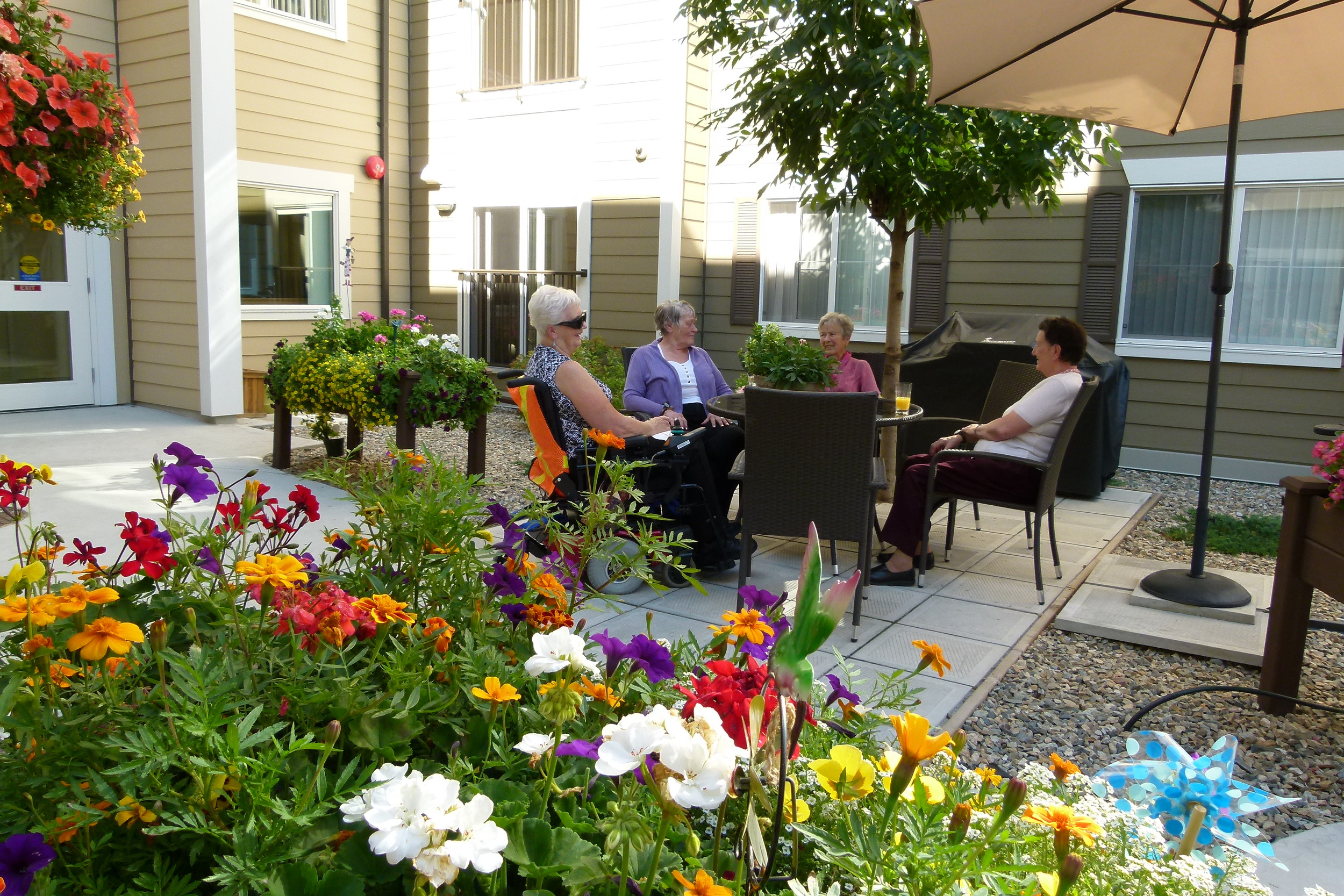 Courtyard 2 Ladies at patio table.JPG