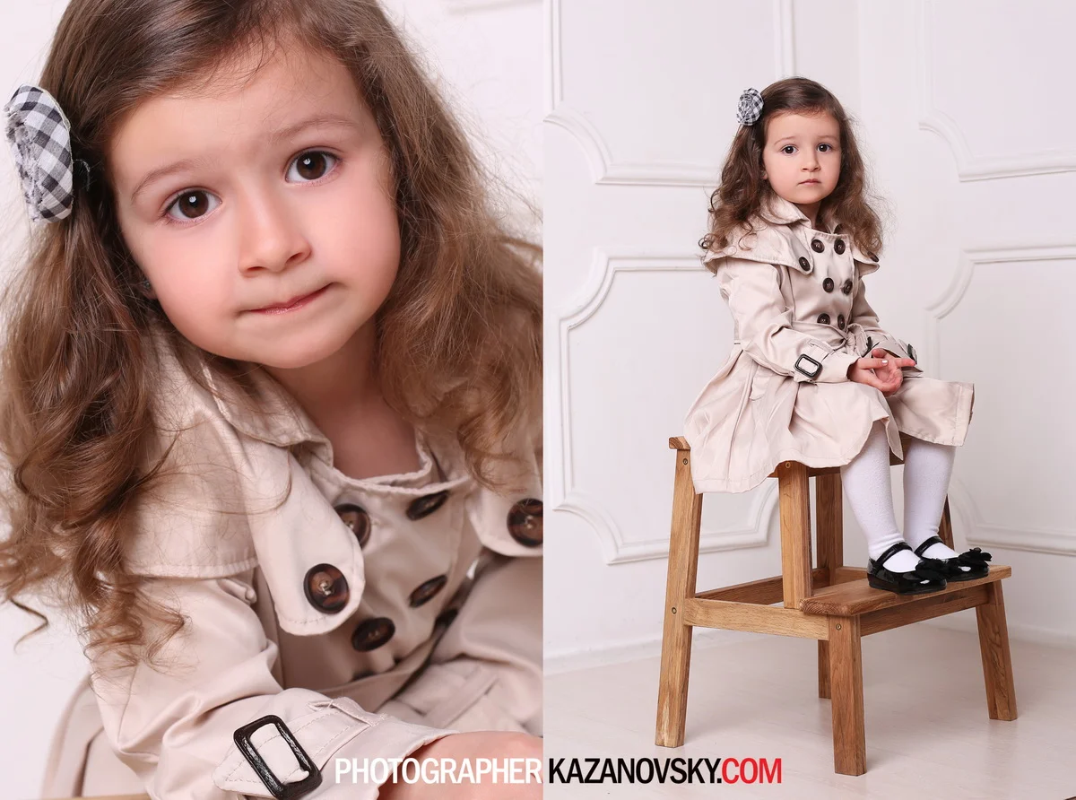 A young girl with long, curly brown hair, wearing a beige trench coat, white tights, and black shoes, sitting on a wooden stool in front of a white wall, looking directly at the camera with a serious expression. The photo is split into two views: a c