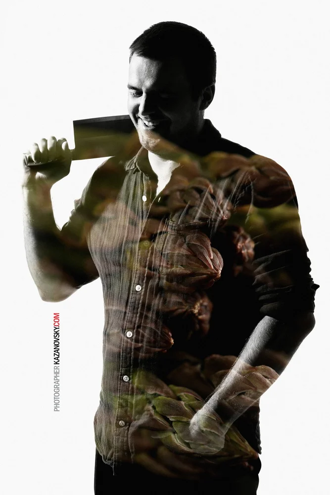 A black-and-white silhouette of a man smiling and holding a bottle, with a colorful overlay of vegetables and leaves on top of the silhouette.