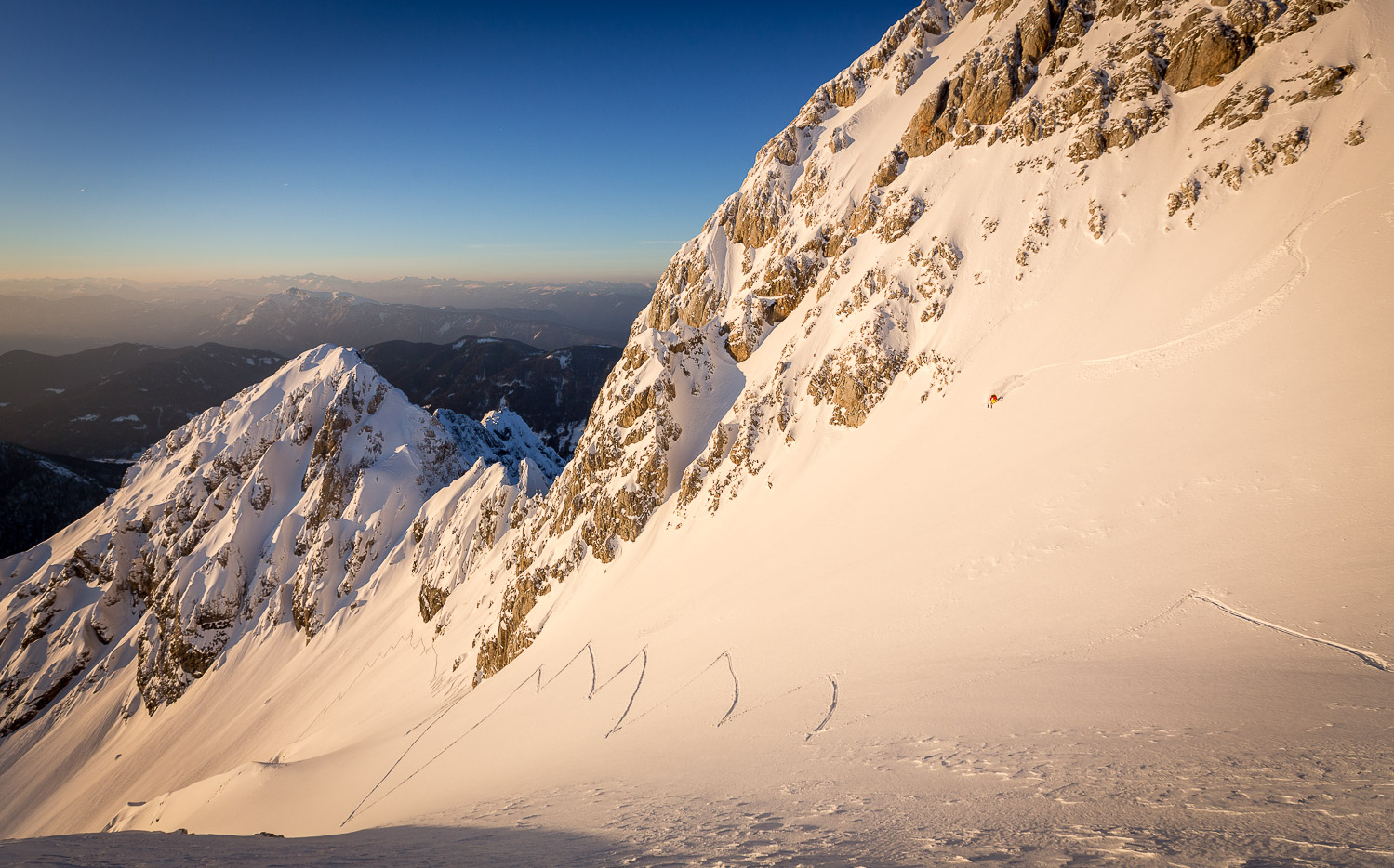 Ski mountaineering and riding powder at sunset, Špik, Julian Alps, Slovenia