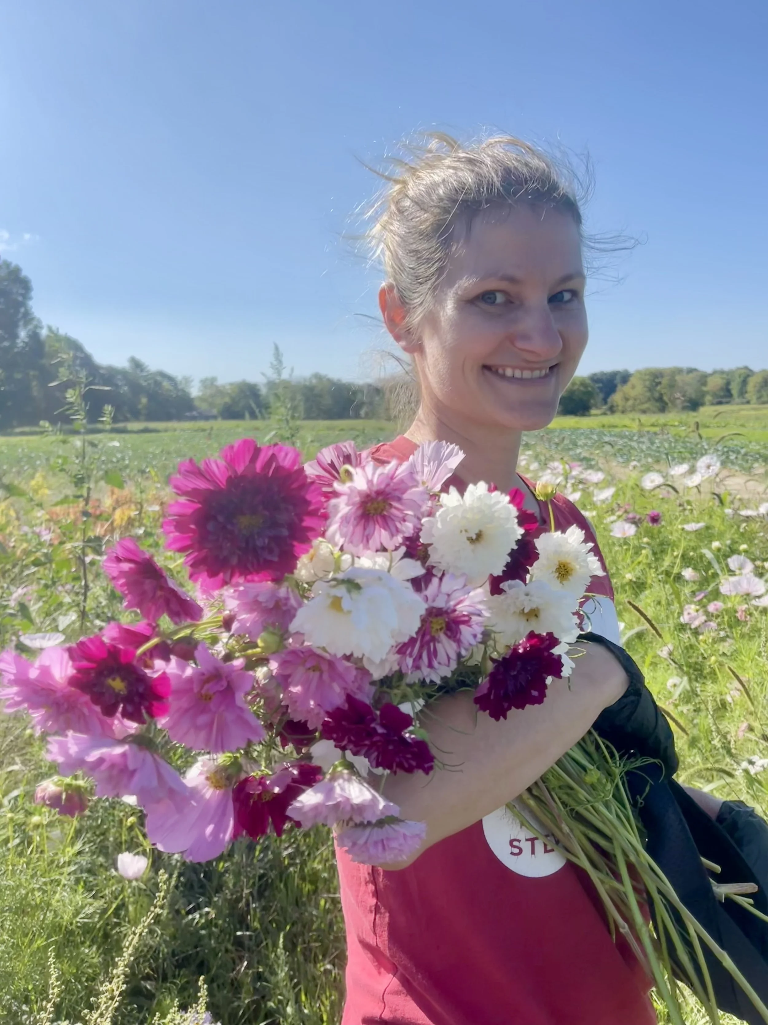 Woman holding purple flowers.