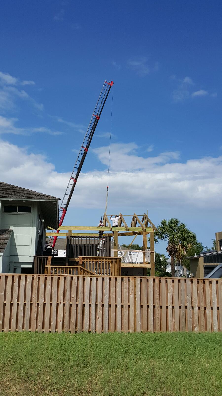 Crane lowering roof trusses