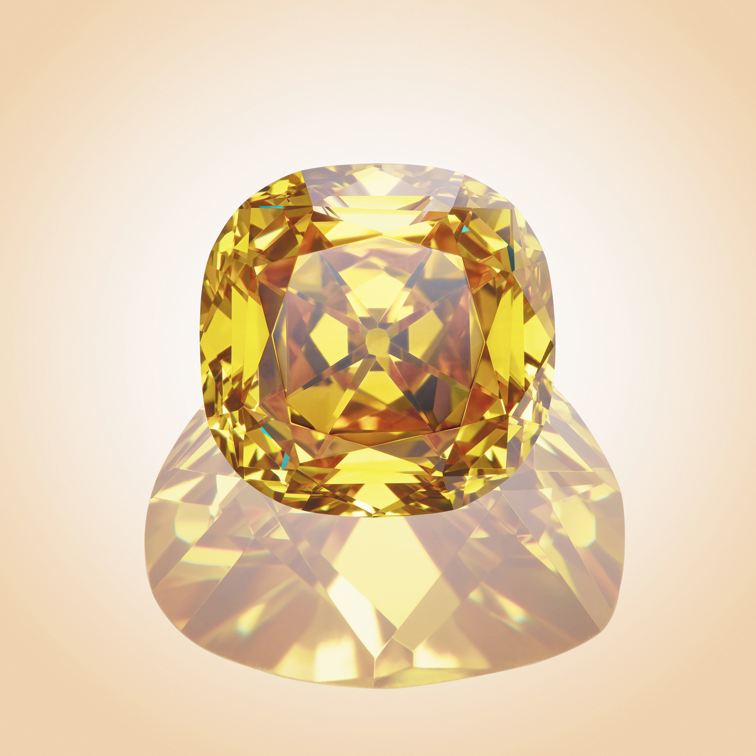 Yellow gemstone with it's reflection on pastel orange