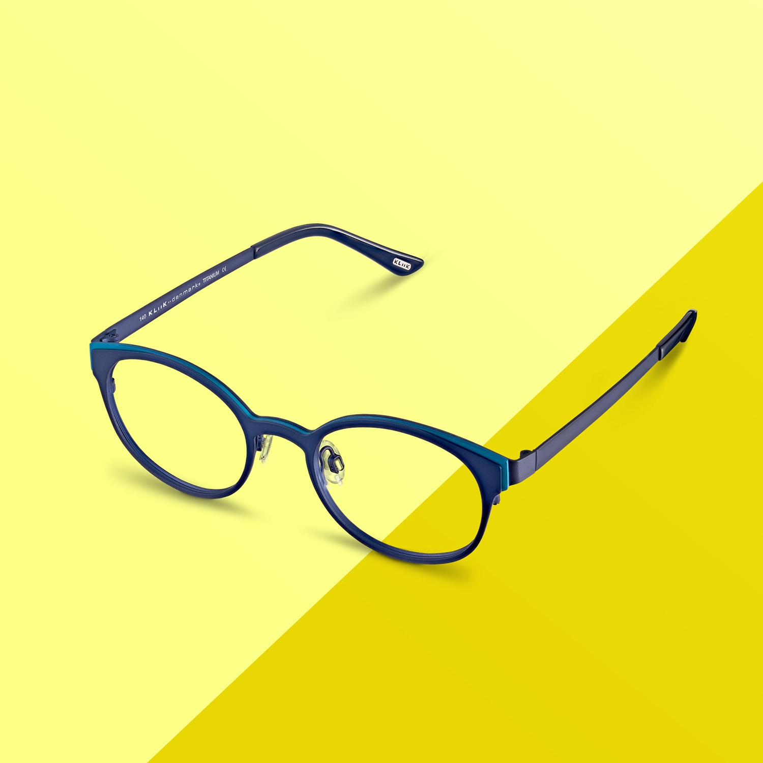 Blue prescription eyewear on a yellow striped background