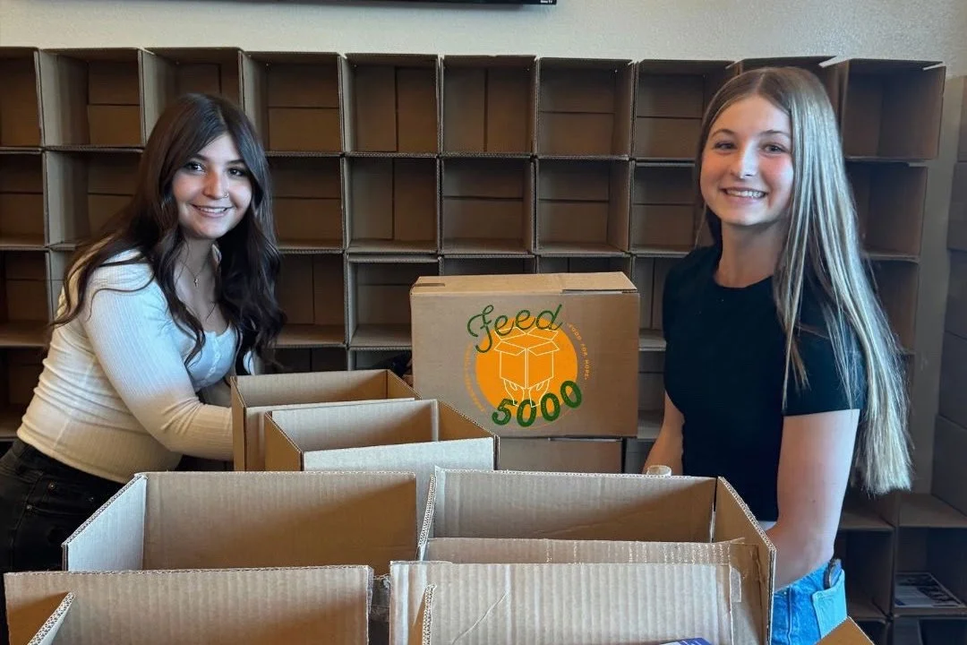 Girls movng Feed 5000 boxes