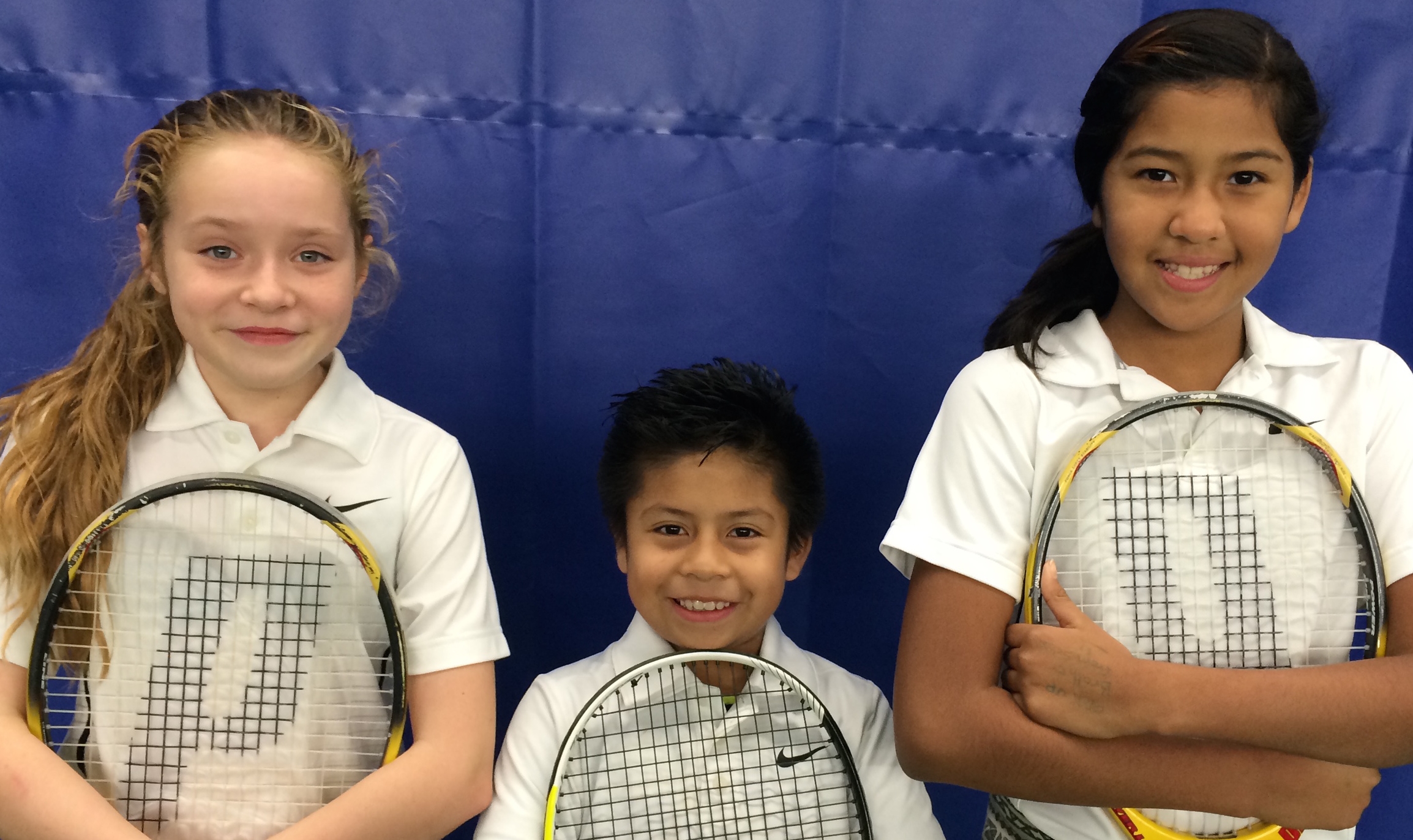 Marissa, Martin, and Ashley celebrate The Kids on the Court's final match.