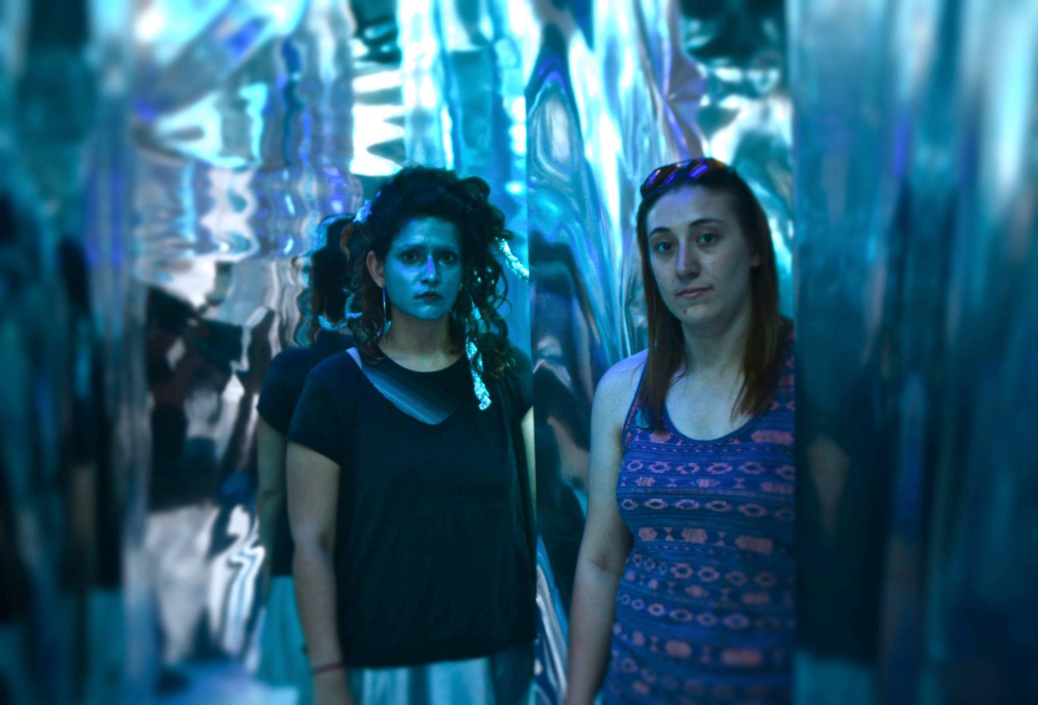 Paige Miller (right and Ashley Carrega transform the gallery one more time. (Photo by Gary Reed)