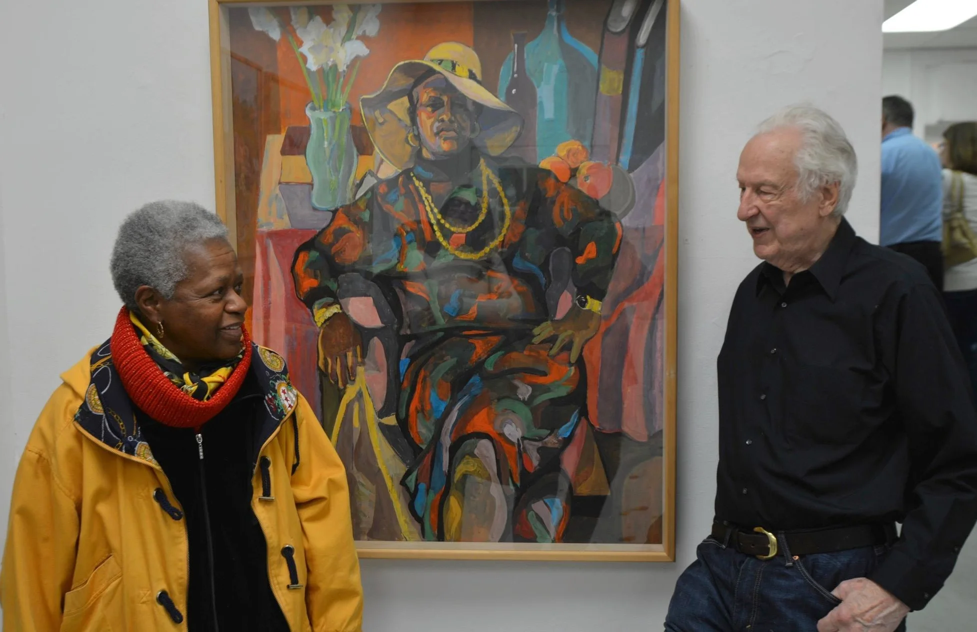 Cynthia, the model in the portrait, chats with Bob at his exhibit.