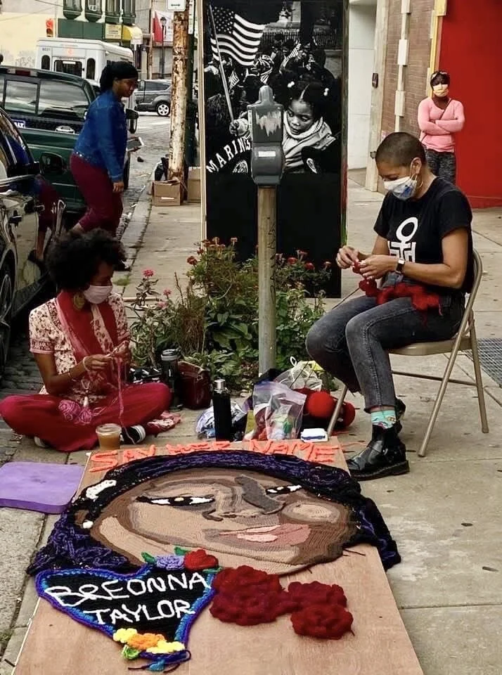 Fiber artists Gina Giles (L) &amp; Linette Kielinski work on Linette’s panel. Photo by Rocio Cabello