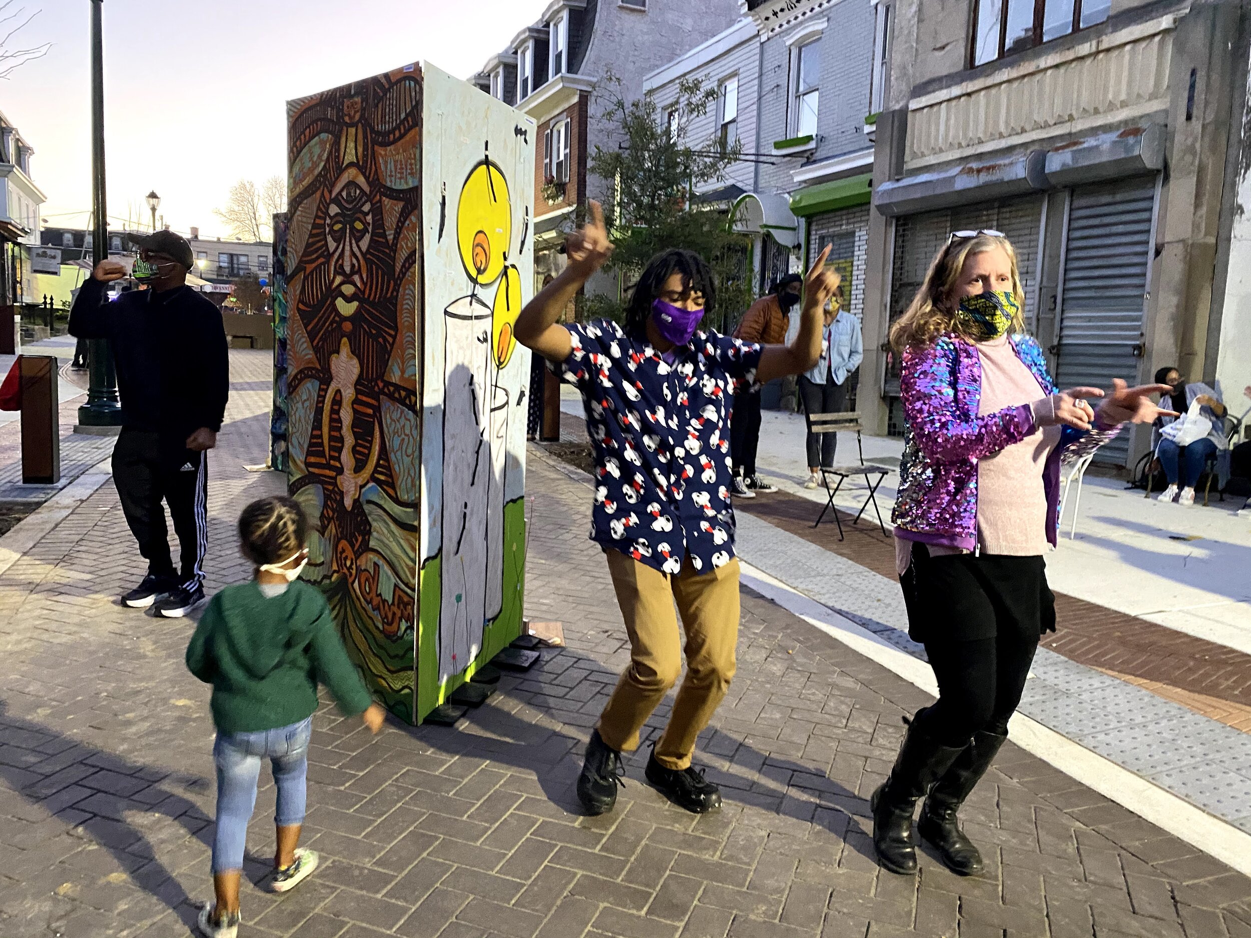 PRISM by Oluwafemi (L) and Renny Molenaar (R). The creator of the PRISMS Isaiah Price dancing with friends celebrating election results.Photo by Rocio Cabello.