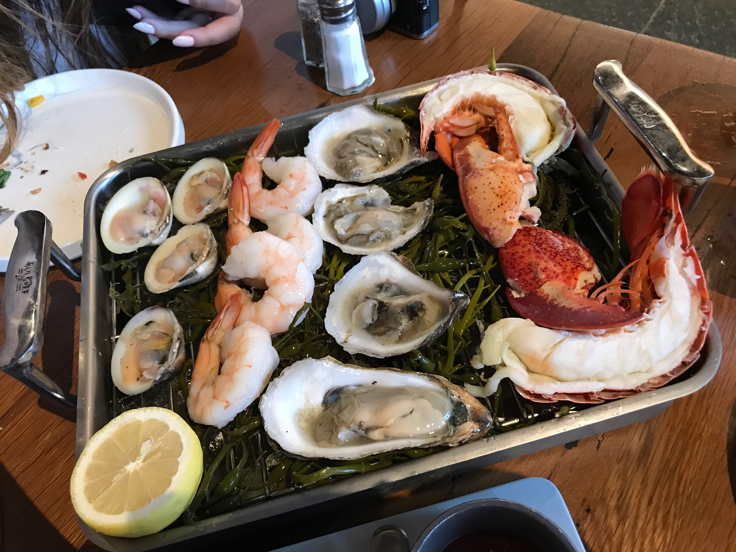 Kitchen 21's RAW BAR IN A BOX - Local Oysters, Jumbo Shrimp Cocktail, Little Neck Clams, Chilled Lobster, Pink Peppercorn Mignonette Sauce, Sun dried Tomato Cocktail, Beet Horseradish