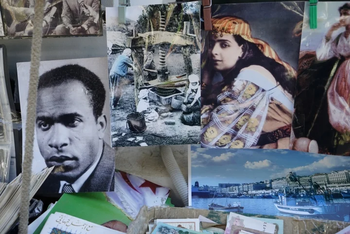 Still from Katia Kameli's short film The Algerian Novel , featuring postcards of Fanon