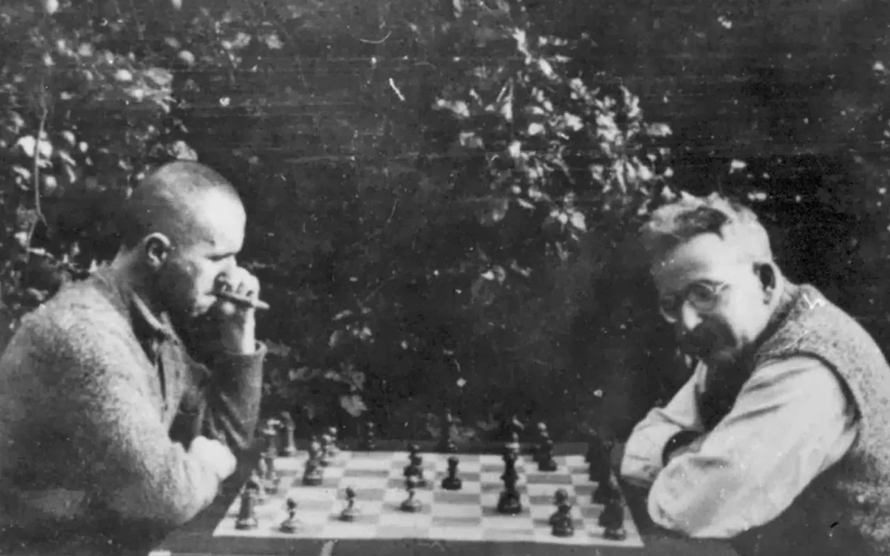 Brecht (left) plays chess with Walter Benjamin (right).