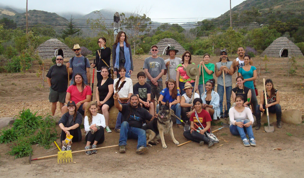 Volunteers helped plant 90 native plants, donated by CalTrout , at the Chumash Village , in a project organized by Breanna Chandler (seated center, in blue), and Kristen Gangl (seated center row, in black). - June 10, 2012