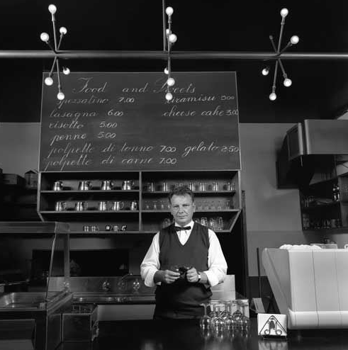 Mark Westcott in the pre-renovated front section of Don Camillo restaurant. Image credit Paul County, from the book When We Eat