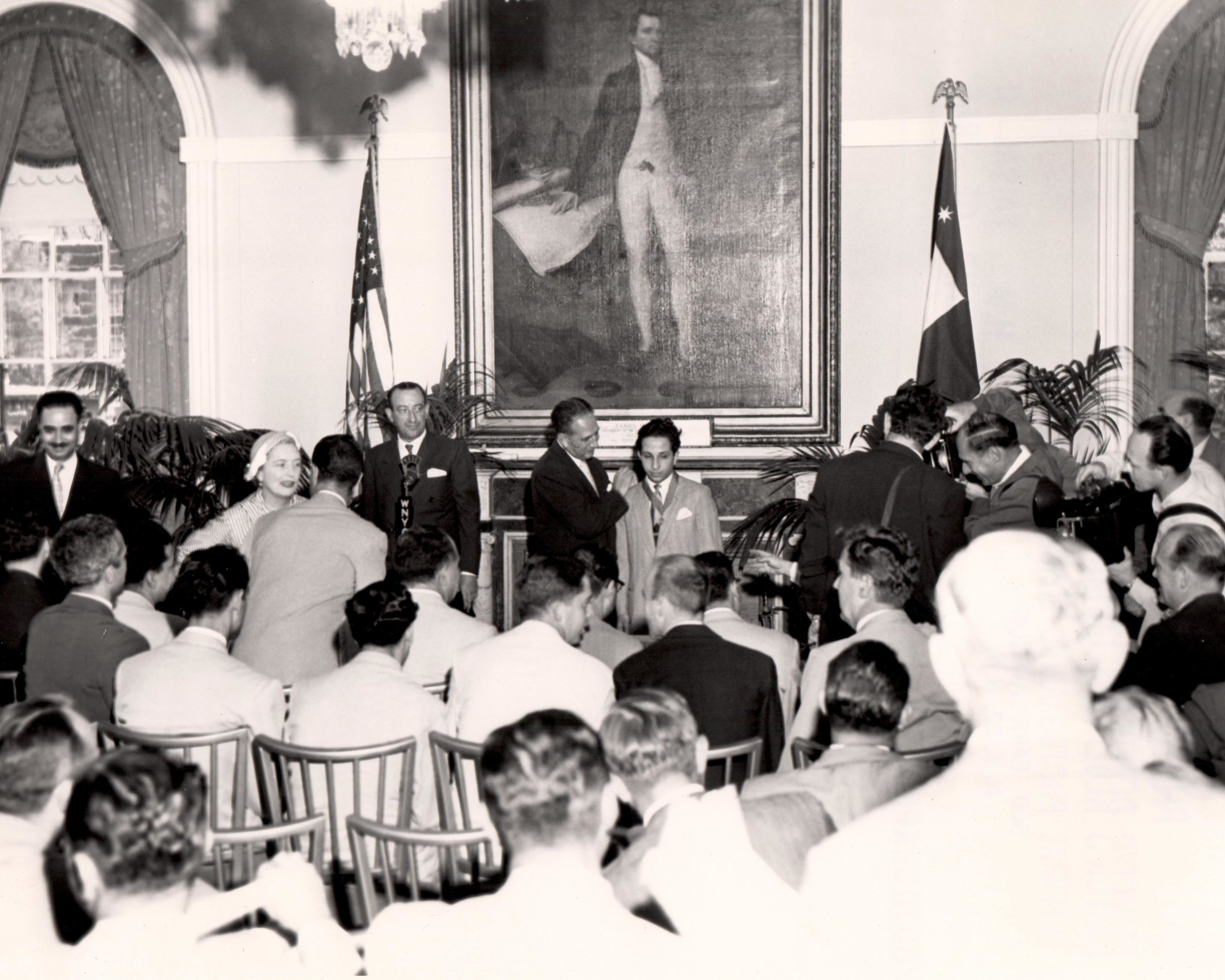 Medal of Honor Mayor Impellitteri awarding King Faisal II with the New York City Medal of Honor inside City Hall’s reception chambers