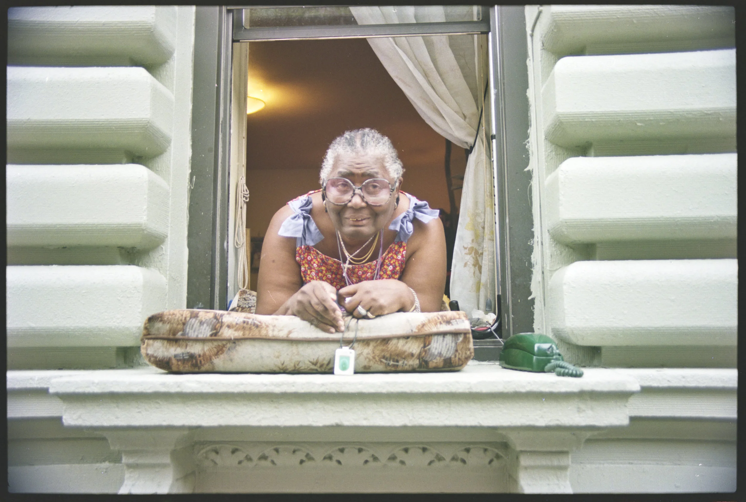 Tenant in window, location unknown,1996. Photograph by Larry Racioppo.