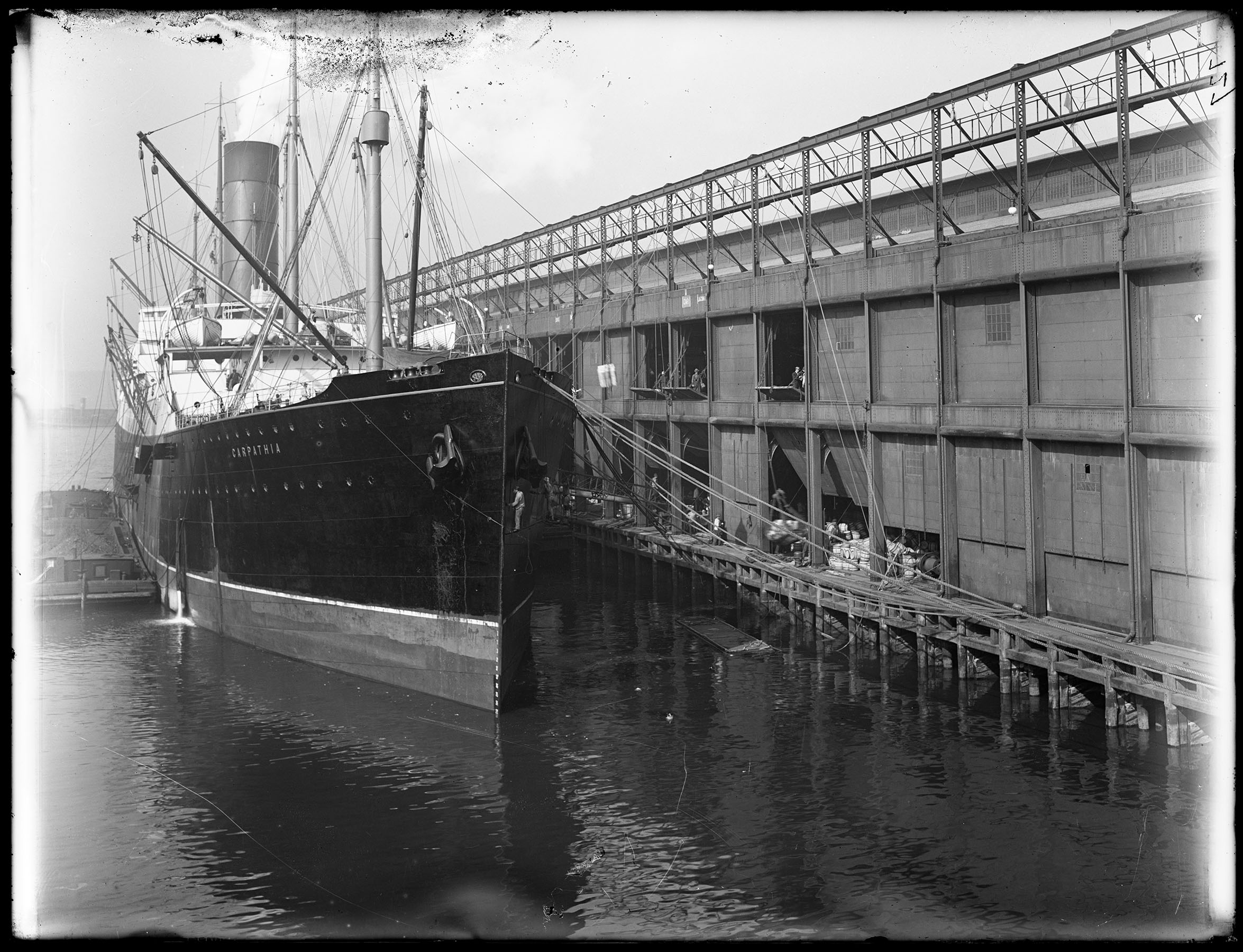 S.S. Carpathia docked at Chelsea Piers, 1912. While we cannot be sure, archivists suspect this photograph was probably taken after the Carpathia arrived with survivors of the Titanic disaster. Department of Docks & Ferries collection, #697, NYC Municipal Archives.
