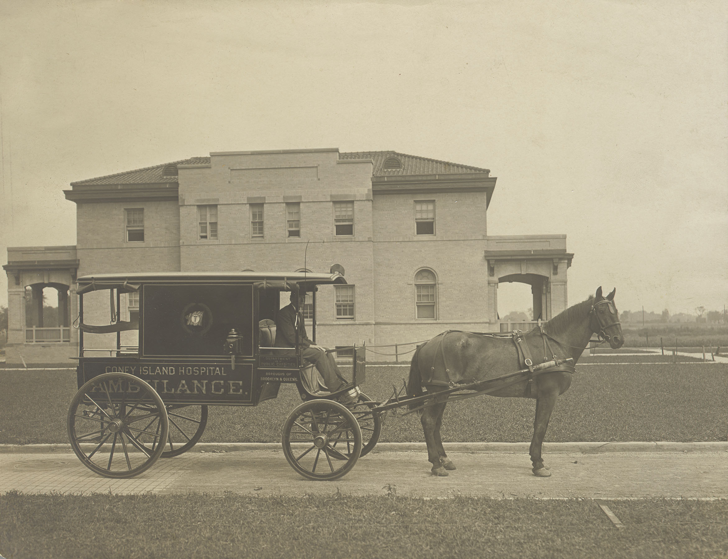 Horse-and-buggy ambulance in front of (Old) Coney Island Hospital, ca. 1900. Department of Public Charities Collection, NYC Municipal Archives.
