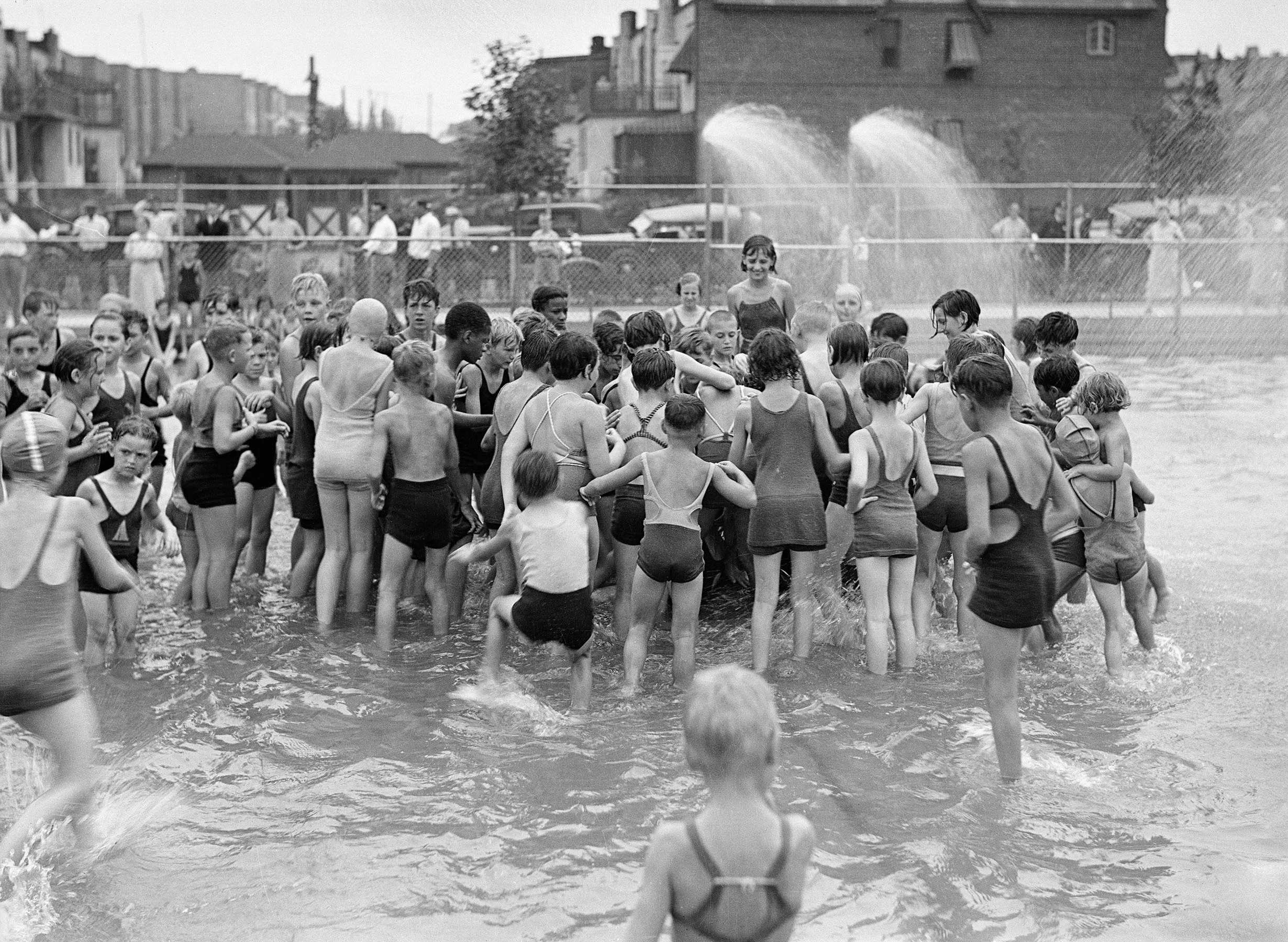 Denis P. Gorman Memorial Playground, Jackson Heights, Queens: Opening ceremonies, children grabbing for melon, August 11, 1934. Department of Parks & Recreation Collection, NYC Municipal Archives.