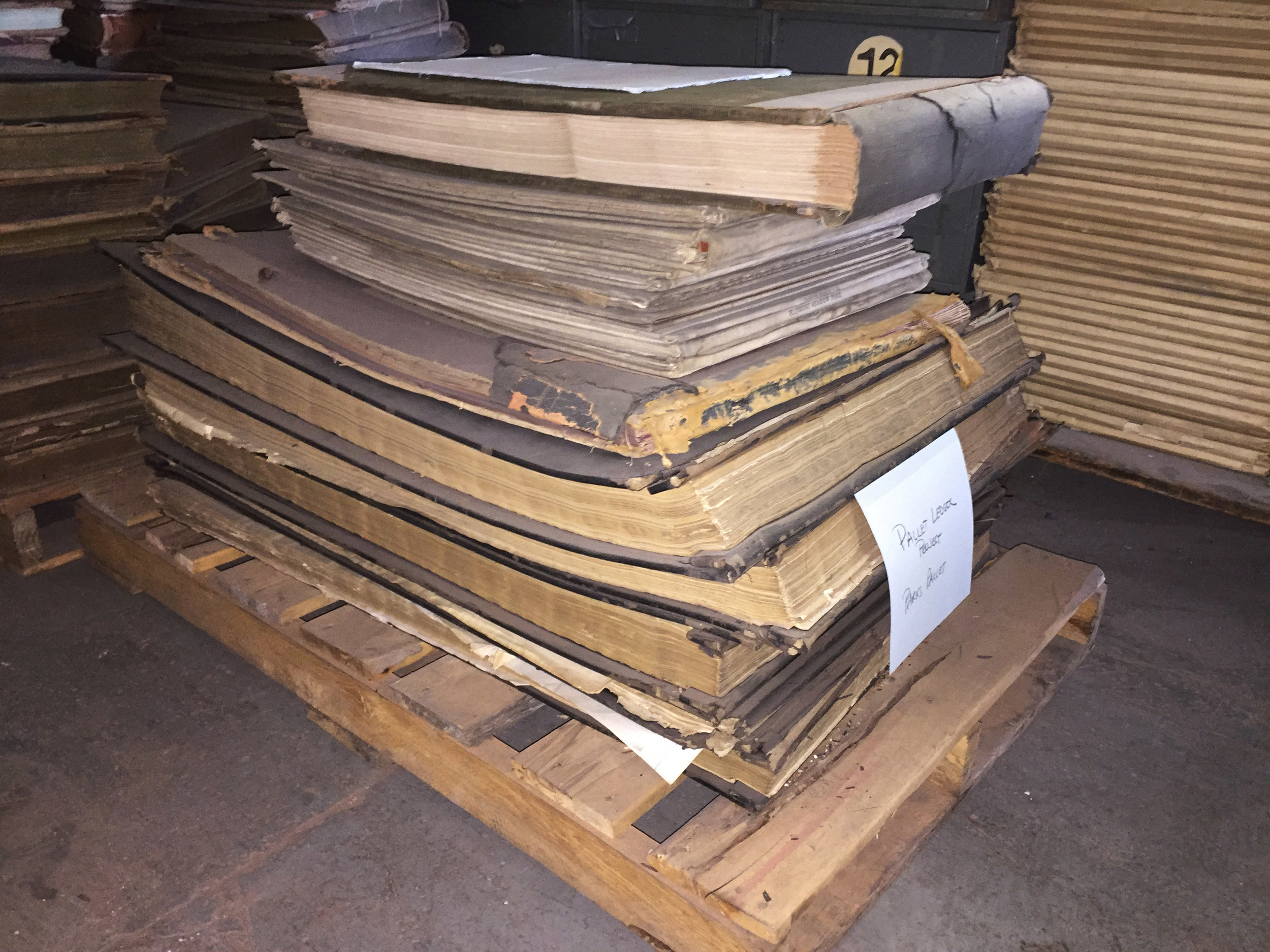 Some of the ledgers saved after a review of pallets at the Municipal Archives warehouse.