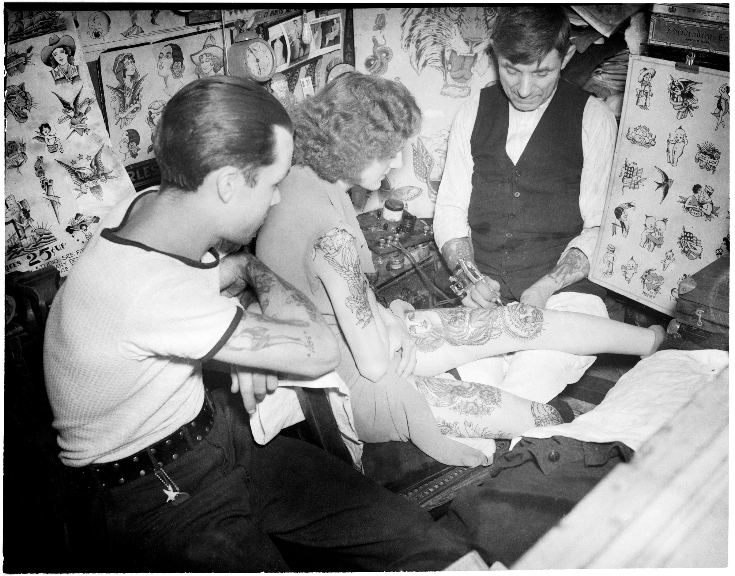 Charlie Wagner tattooing a woman at his world-famous Bowery studio, 11 Chatham Square. Date: 1938. Photographer: Daniel Triestman. WPA-FWP Collection, NYC Municipal Archives.
