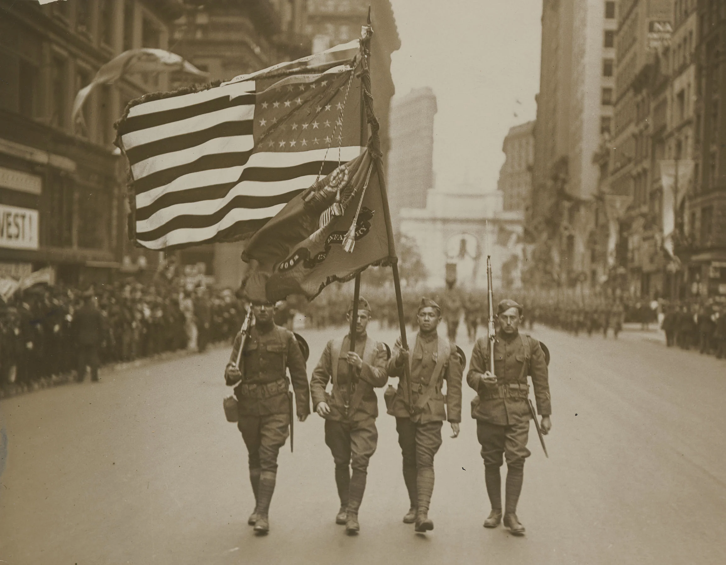 Parade of the 77th Division, May 6, 1919. Color sergeant Sing Kee (2nd from right), was awarded the Distinguished Service Cross and the French Croix de Guerre. He was the first Chinese American to be decorated for bravery. Underwood & Underwood. Mayor’s Reception Committee, NYC Municipal Archives.