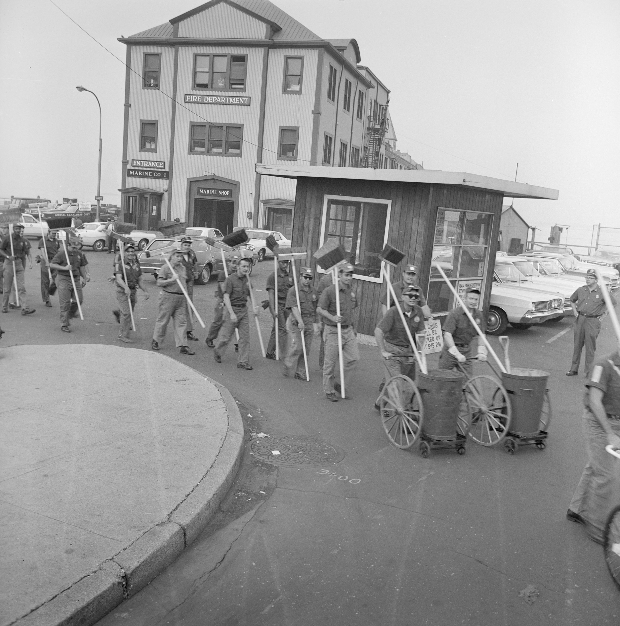 Sanitation workers in front of Pier A preparing to clean up after the parade, August 13, 1969. Department of Sanitation Collection, NYC Municipal Archives.