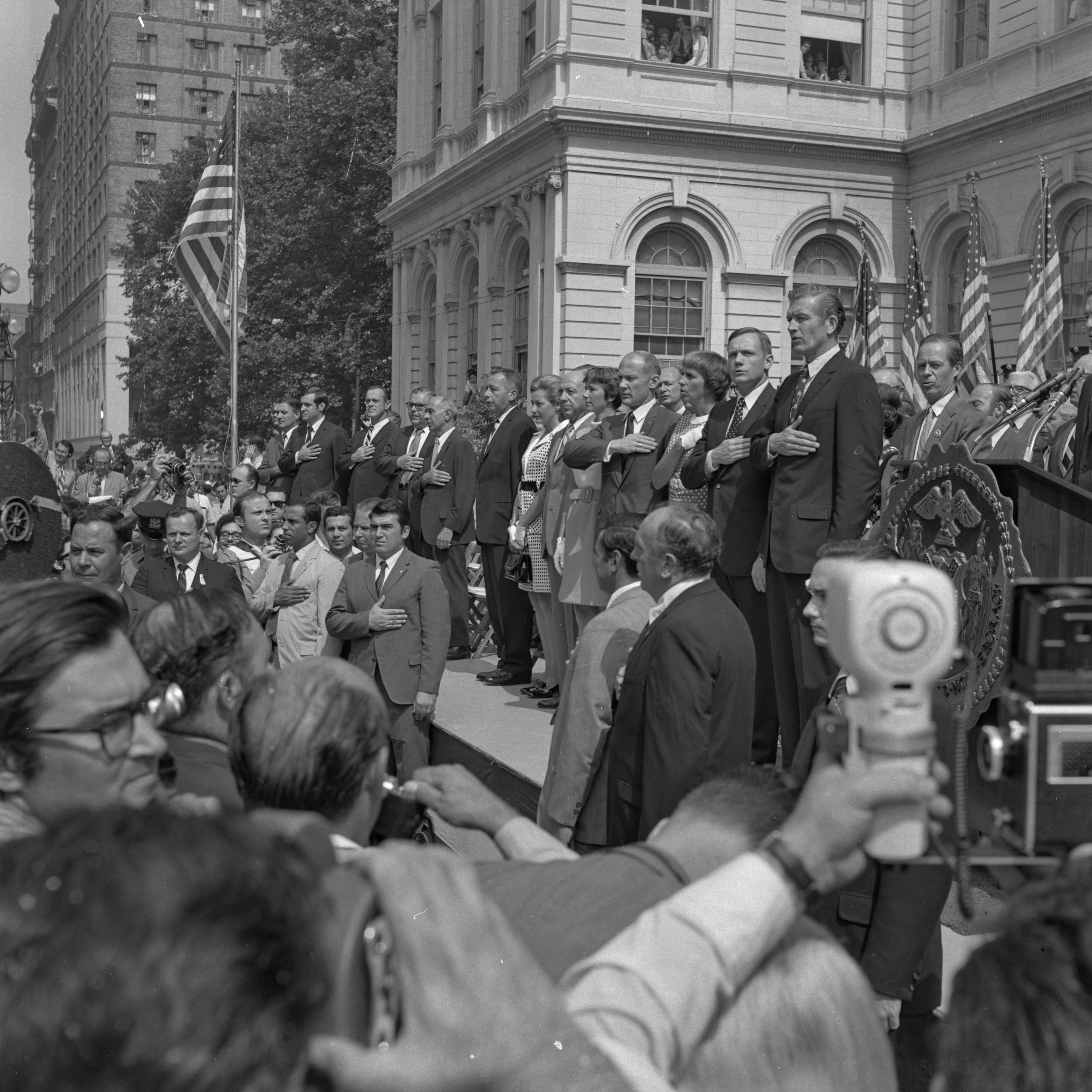 City officials, Apollo 11 Astronauts, and their families recite the pledge of allegiance on the steps of City Hall, August 13, 1969. NYPD Collection, NYC Municipal Archives.