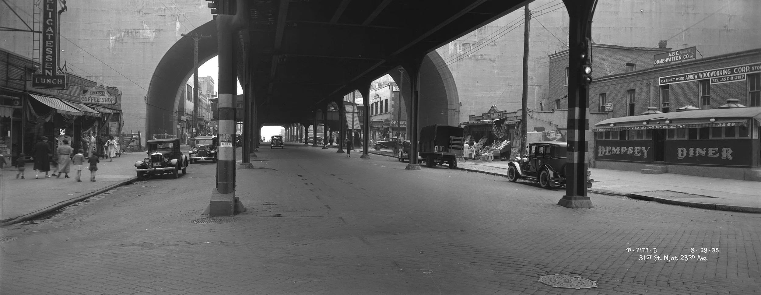 Under the elevated train, 31st Street, looking north at 23rd Avenue, Queens, August 28, 1935. Borough President Queens Collection, NYC Municipal Archives.