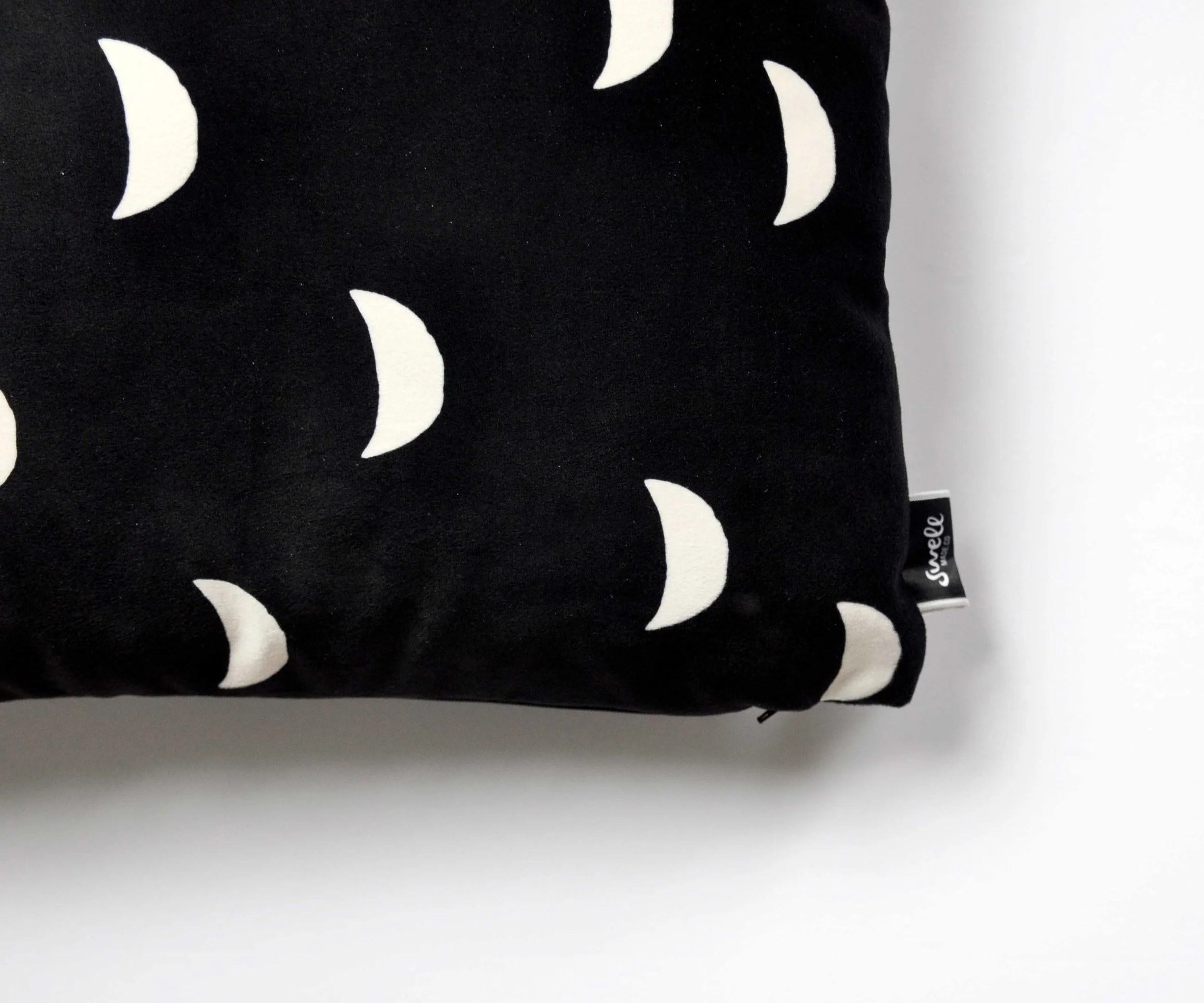 Detail of the moons velveteen throw pillow. By Swell Made Co.
