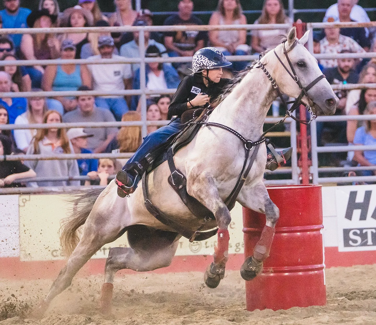 A girl races a horse around barrels at a rodeo in Vermont. Photo by Josh Trudell