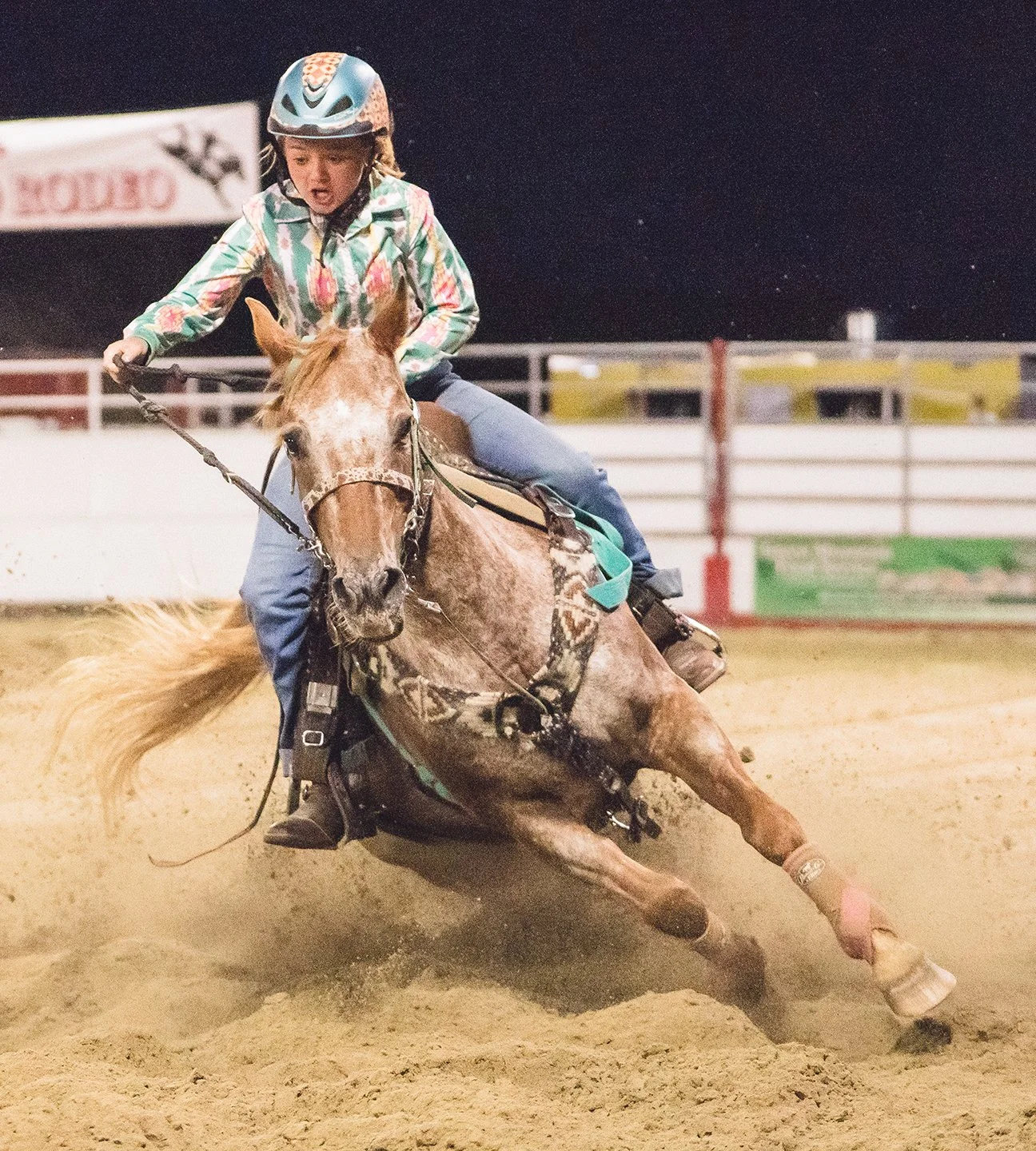 A young girl races a horse around barrels at a rodeo in Vermont. Photo by Josh Trudell