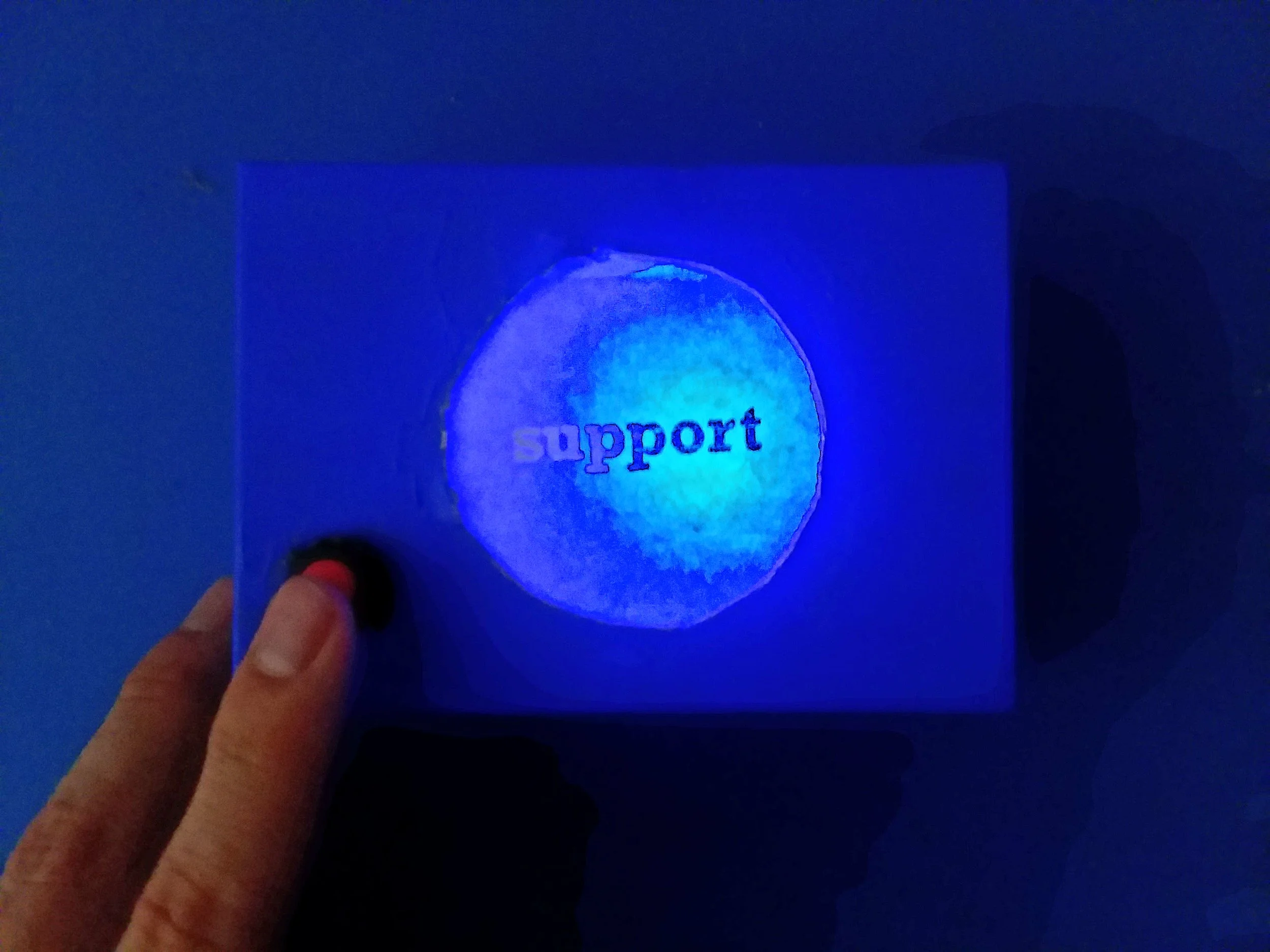 This “support” box uses a simple circuit, a blue LED, and a basic button to let people know when it’s time to give support. Support can be so simple. I’m also interested in blue as the color for help , as it is also a synonym for sadness. This box was made as a gift for the Support team at Foursquare .
