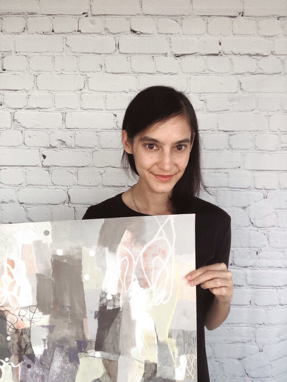 Artist holding works on paper