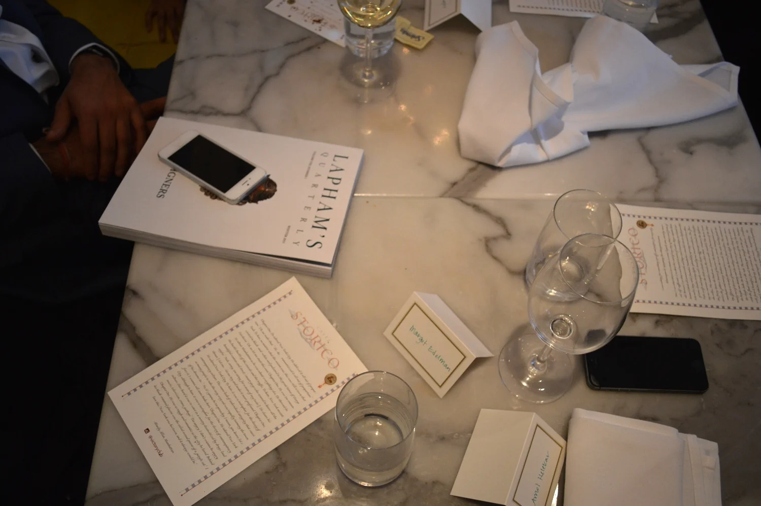An aerial shot after lunch had been cleared, which included the menus turned over for discussion of the literary passages. 