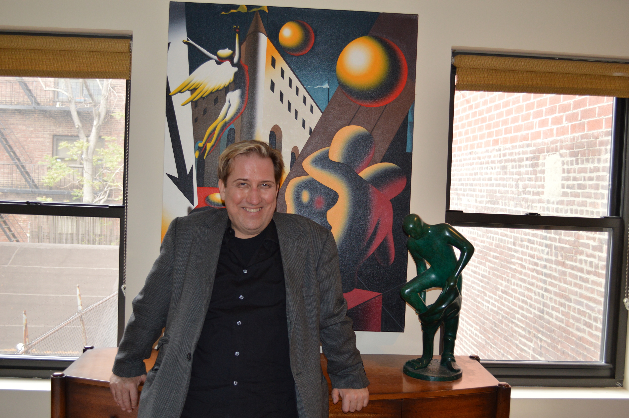 Mark Kostabi posing in front of his work. 