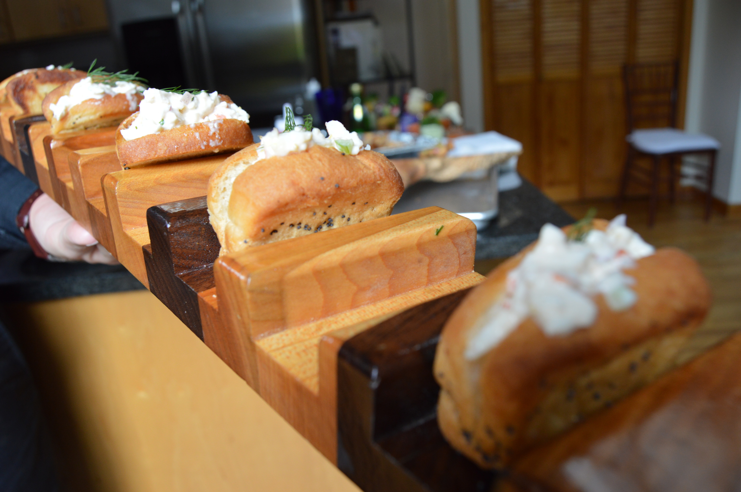 Miniature lobster rolls, served on a platter designed by Paul Neuman