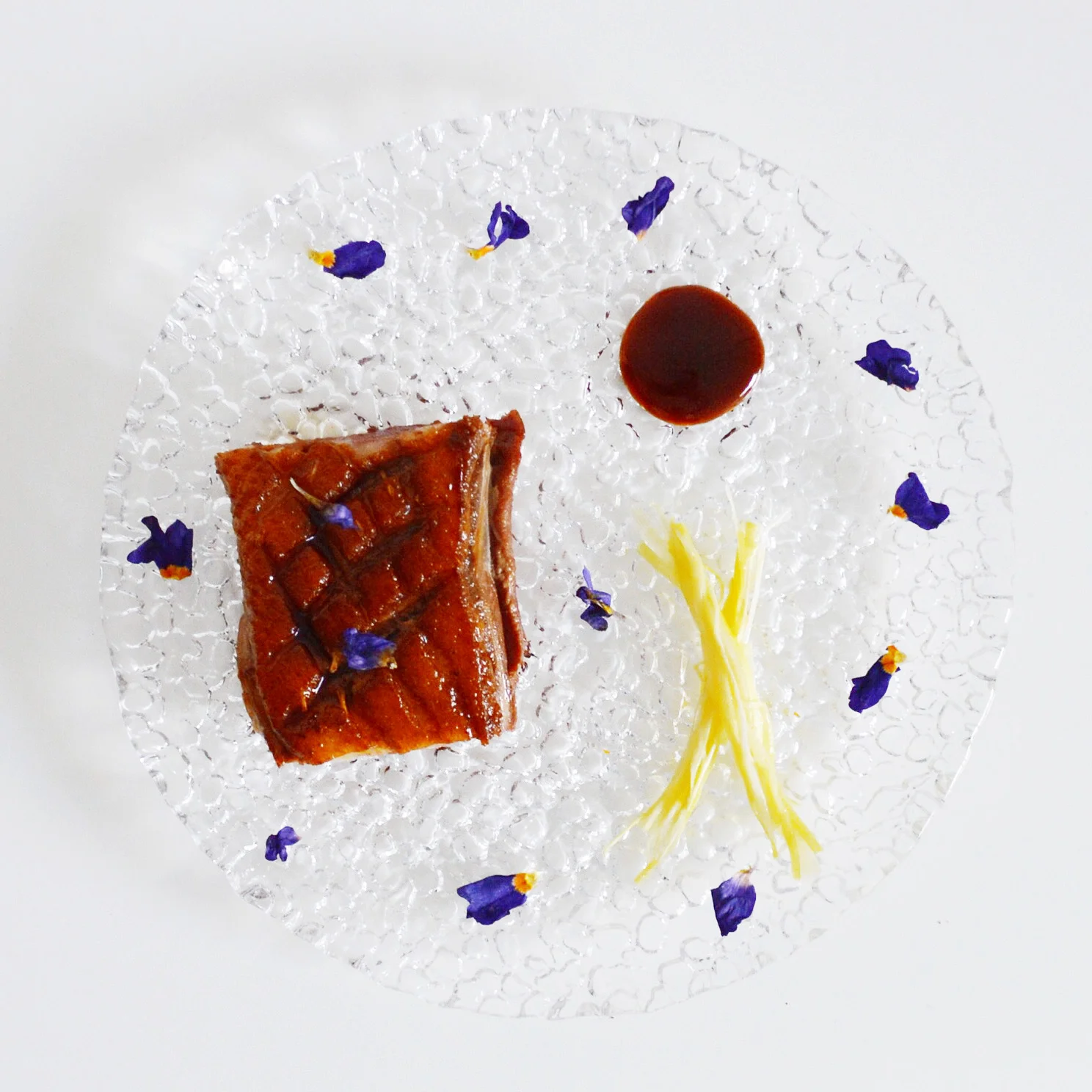 Magret de Canard with Braided Leeks, Plum Sauce, and Flower Petals&nbsp;