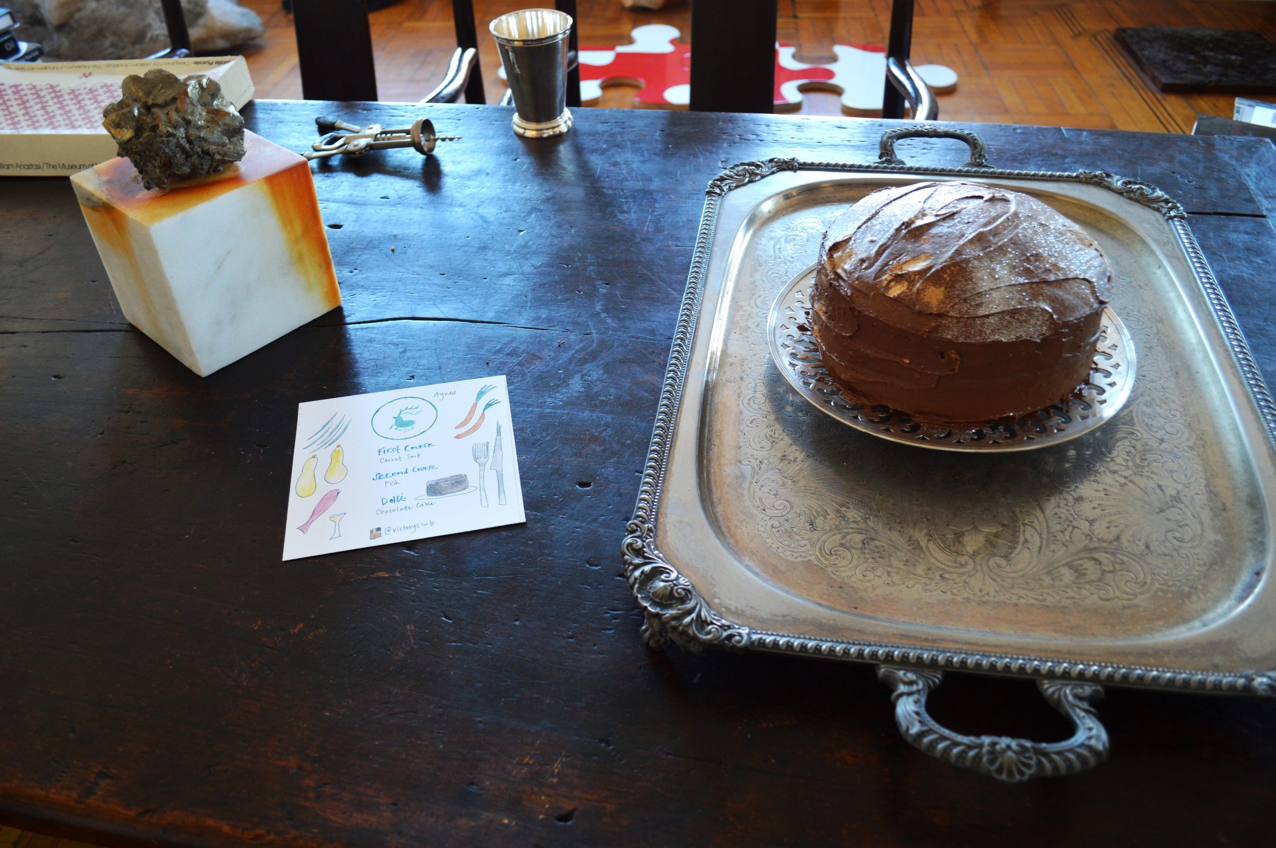 Chocolate cake dusted with 18K gold powder, beside Bradshaw's sculptures