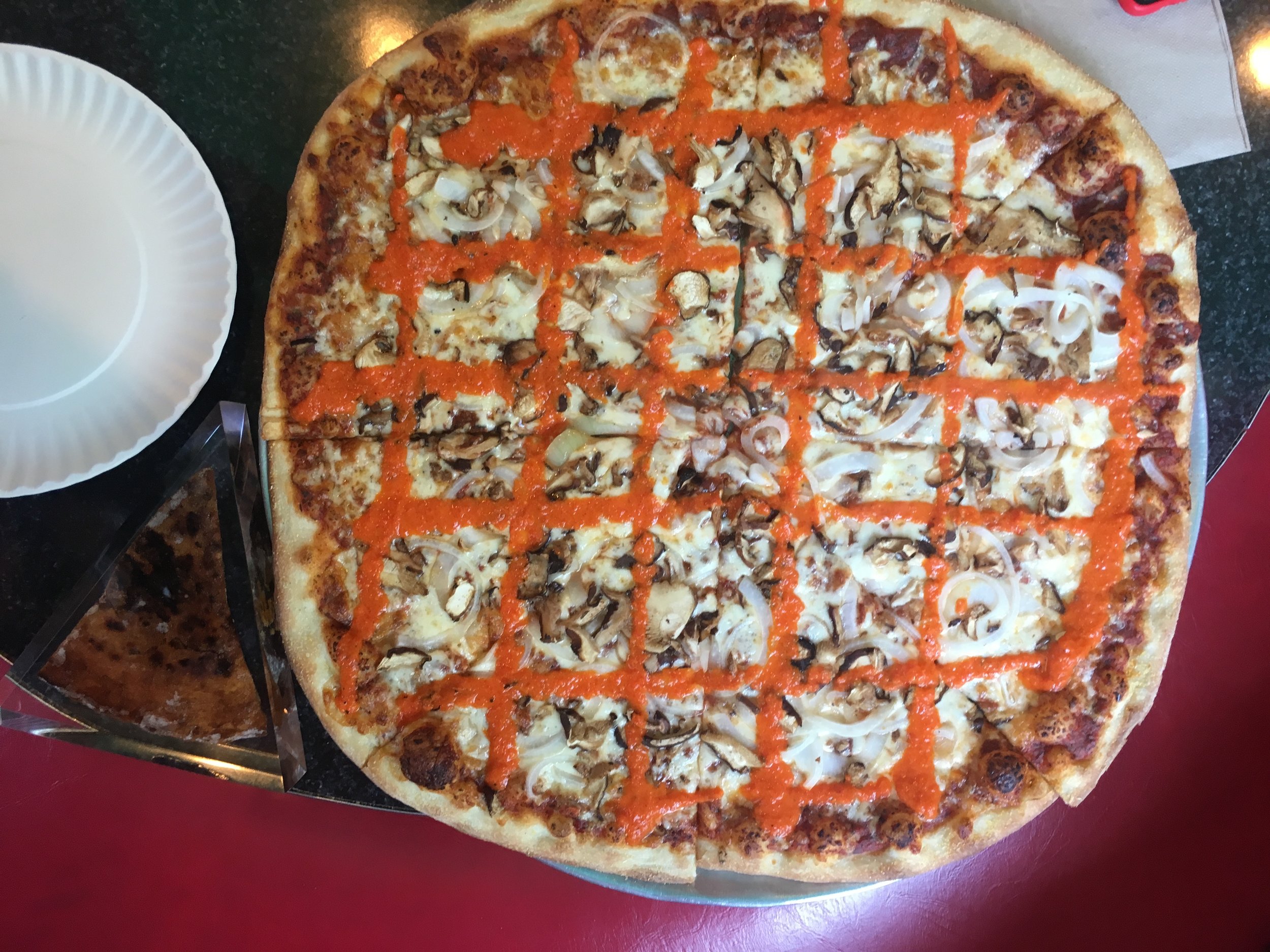 The " Tony Clifton " pizza pie served at Two Boots Pizza .