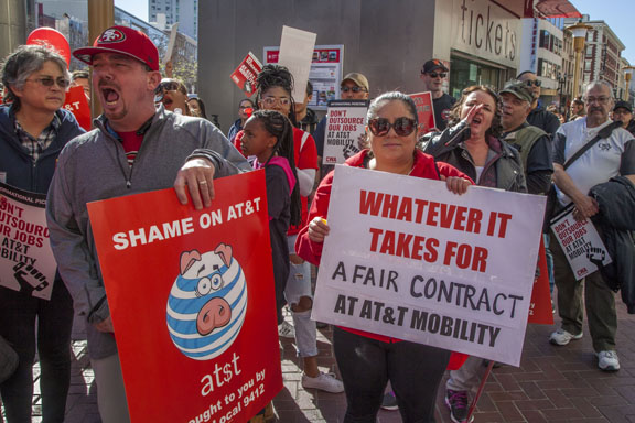 SAN FRANCISCO, CA - Feb. 11, 2017. Workers at AT&T Mobility protest the unwillingness of the company to agree to a new union contract. Members of Communications Workers of America held picket signs, marched and rallied in front of the AT&T Mobility office at the Powell Street cable car turnaround, one of the company's largest consumer offices, in one of the busiest tourist destinations in San Francisco. Photo copyright David bacon.