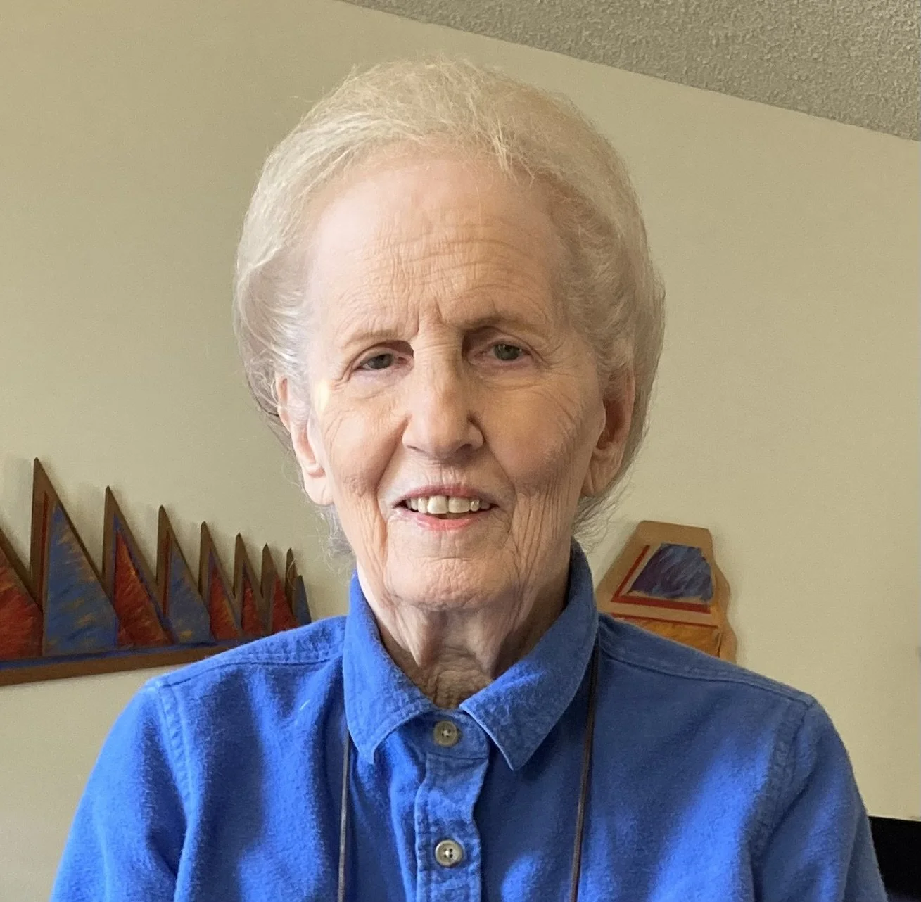 Linda at 90 with wood sculpture, 2025