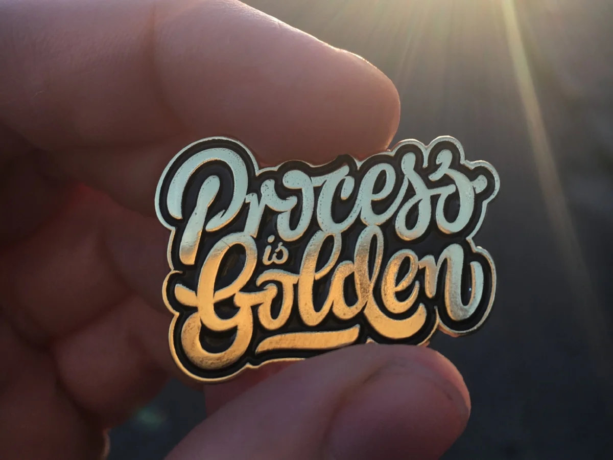 Every attendee received this golden pin attached to their conference badge. Type design: Mark Caneso