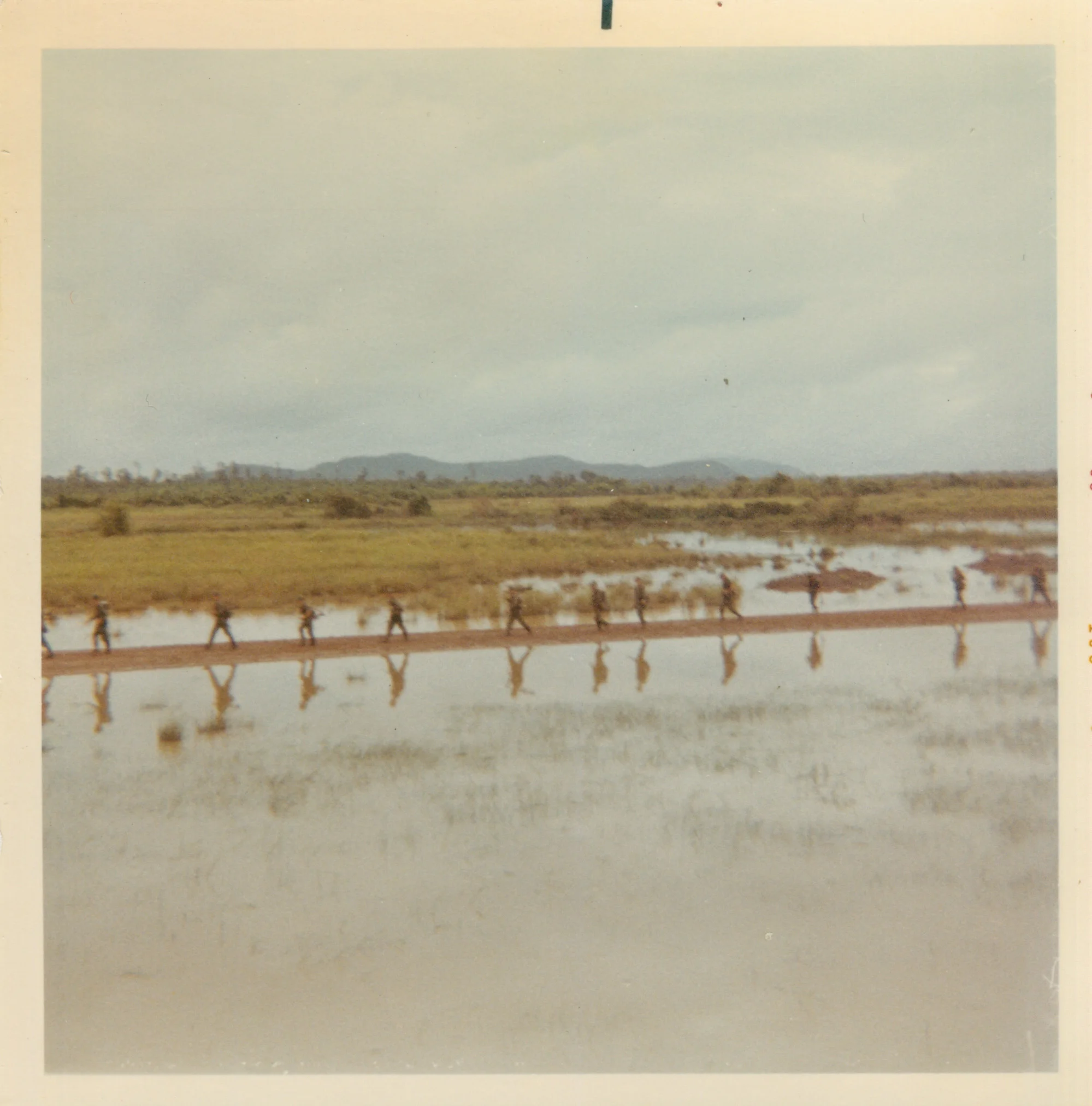   The 1st Battalion (Mechanized),&nbsp;5th Infantry walk North out of Dau Tieng, Vietnam in the summer of 1968. On August 21st, the unit was ambushed and they lost 17 men in the Battle of Ben Cui. (Photograph by Donald Elverd)  