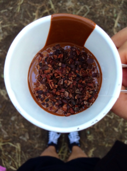 Guittard Liquid Chocolate Bars A melted chocolate bar topped with toffee bits, mini chocolate chips, cacao nibs, and almonds.