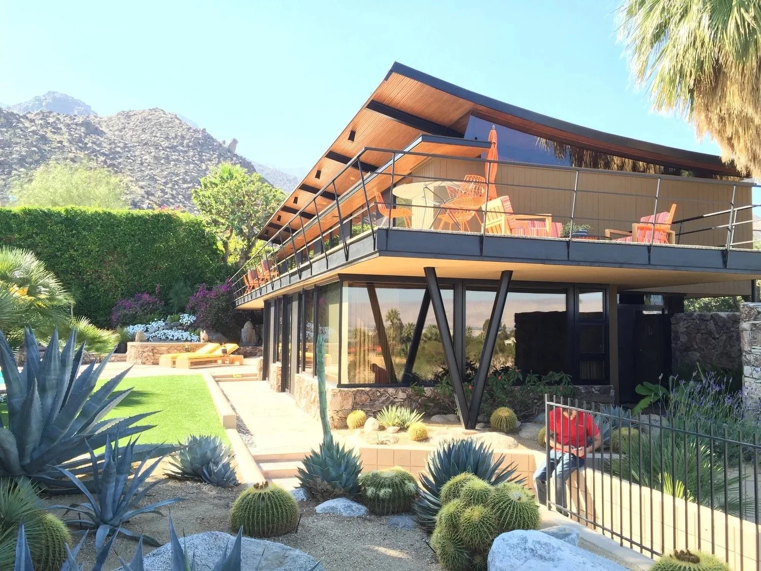 Modern Coachella Valley desert home with large glass windows and mountain views